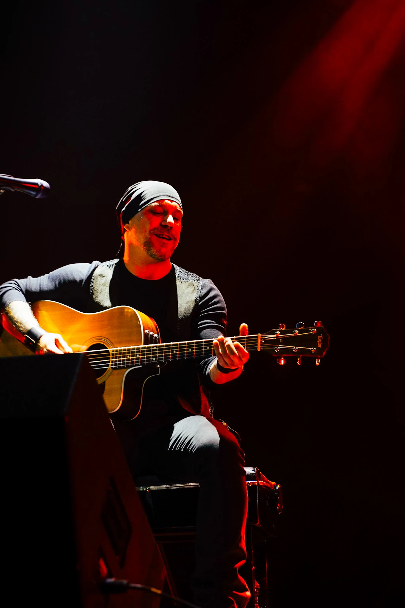 Guitar Art Festival acoustic guitarist performing under red stage lights by Lunar Lens Creative Agency