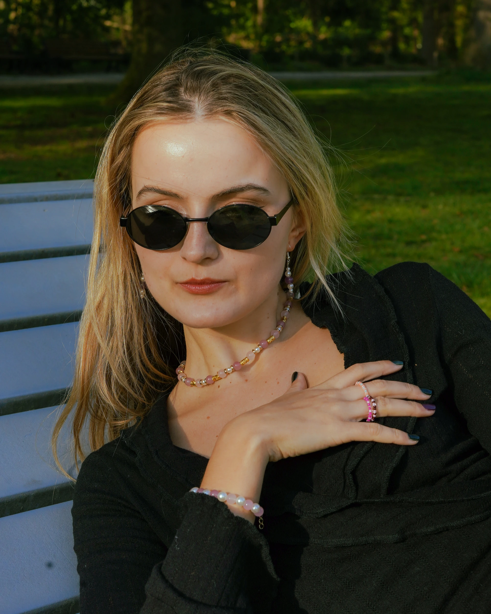 Fashion portrait of a woman wearing sunglasses and beaded jewellery by Lunar Lens Creative Agency