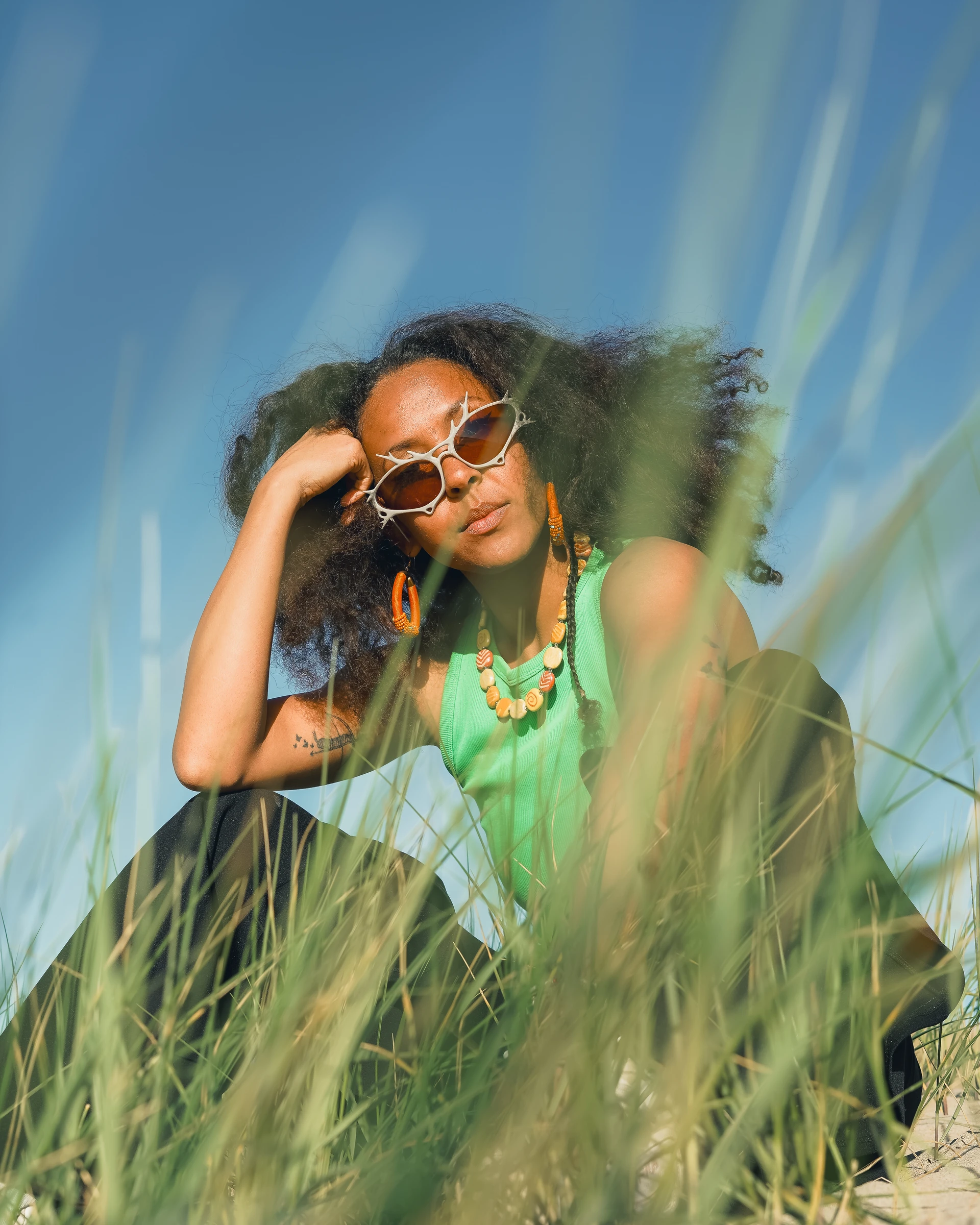 ITURA Studio eyewear campaign portrait through dune grass by Lunar Lens Creative Agency