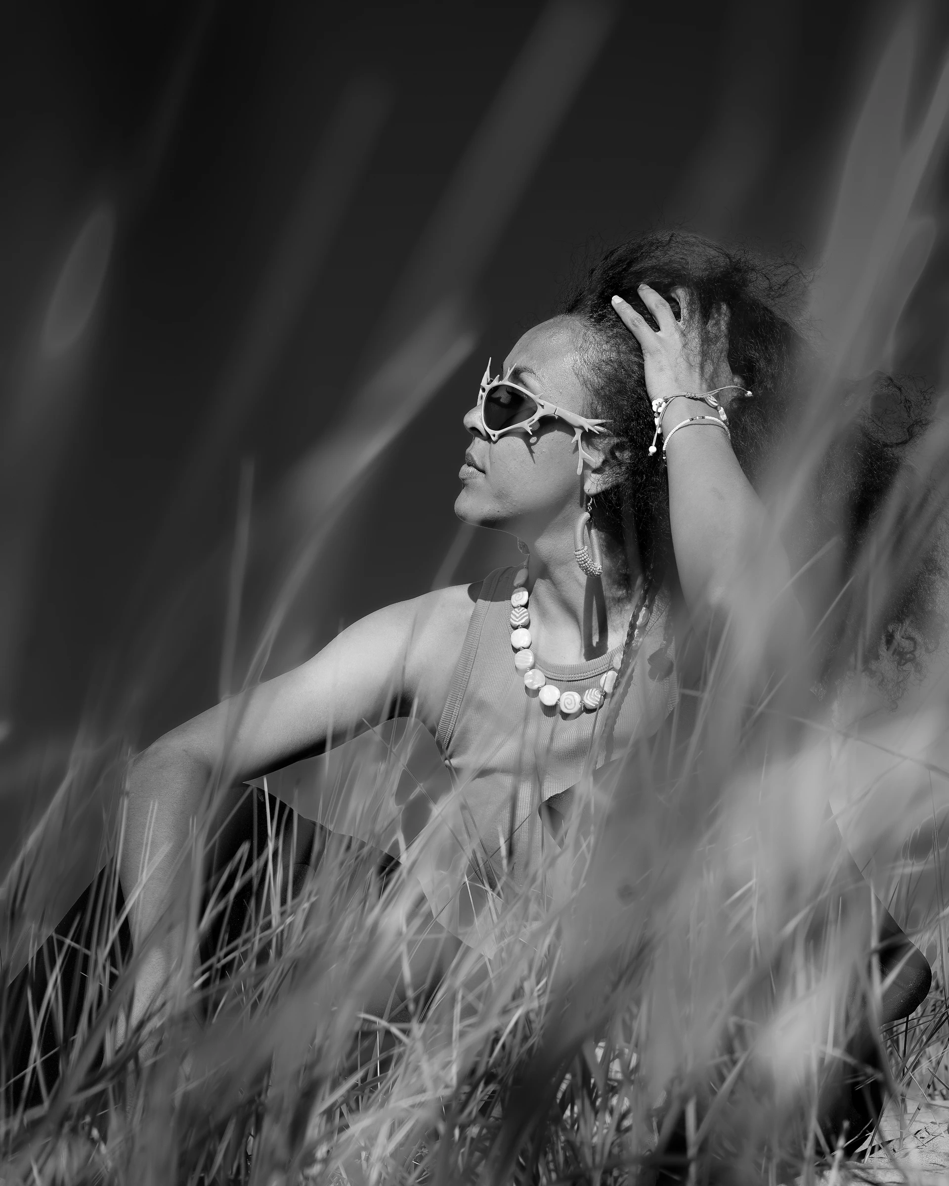 Black-and-white ITURA Studio portrait through beach grass by Lunar Lens Creative Agency