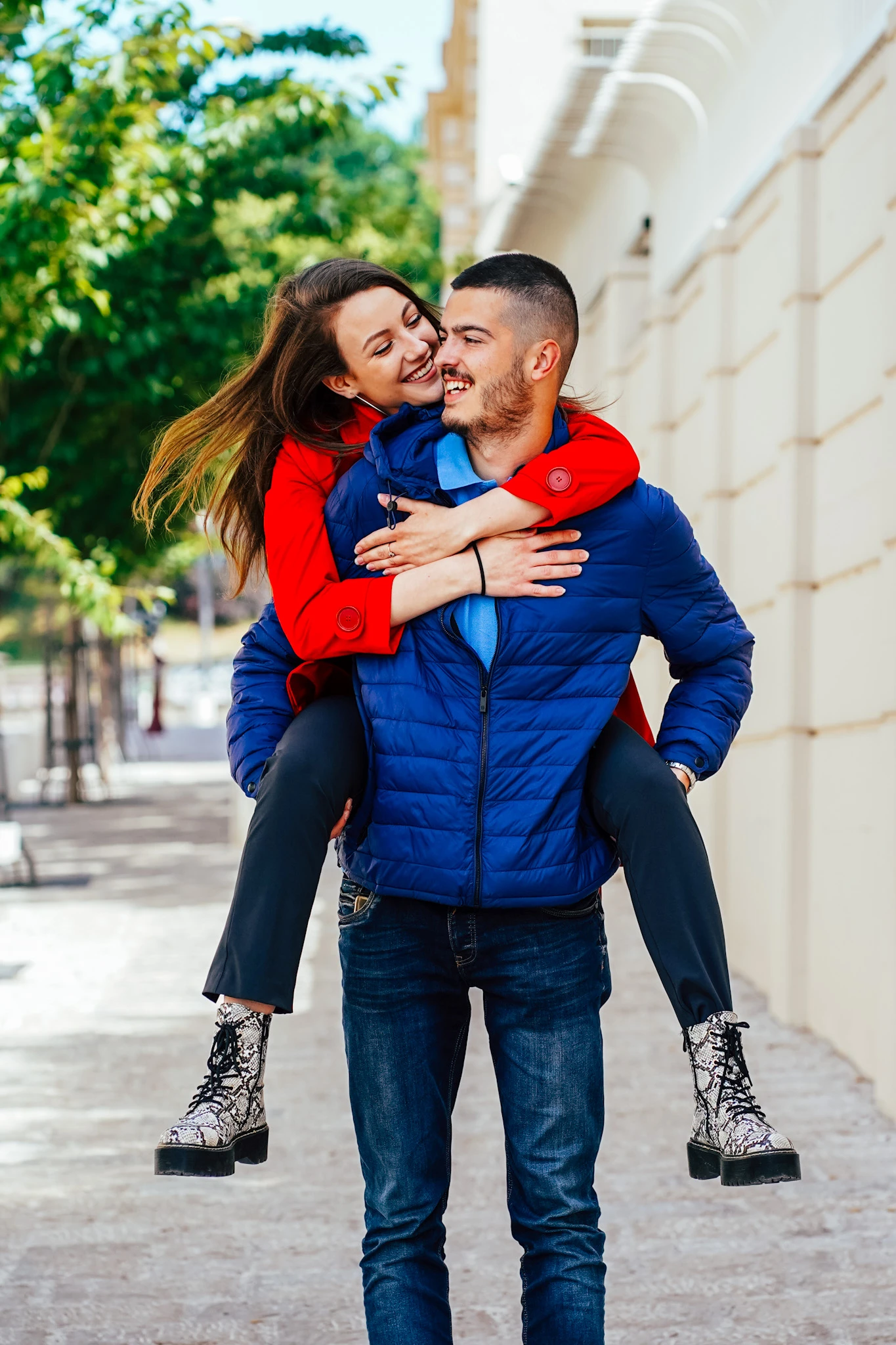 Outdoor couple portrait with a smiling pair on a city street by Lunar Lens Creative Agency