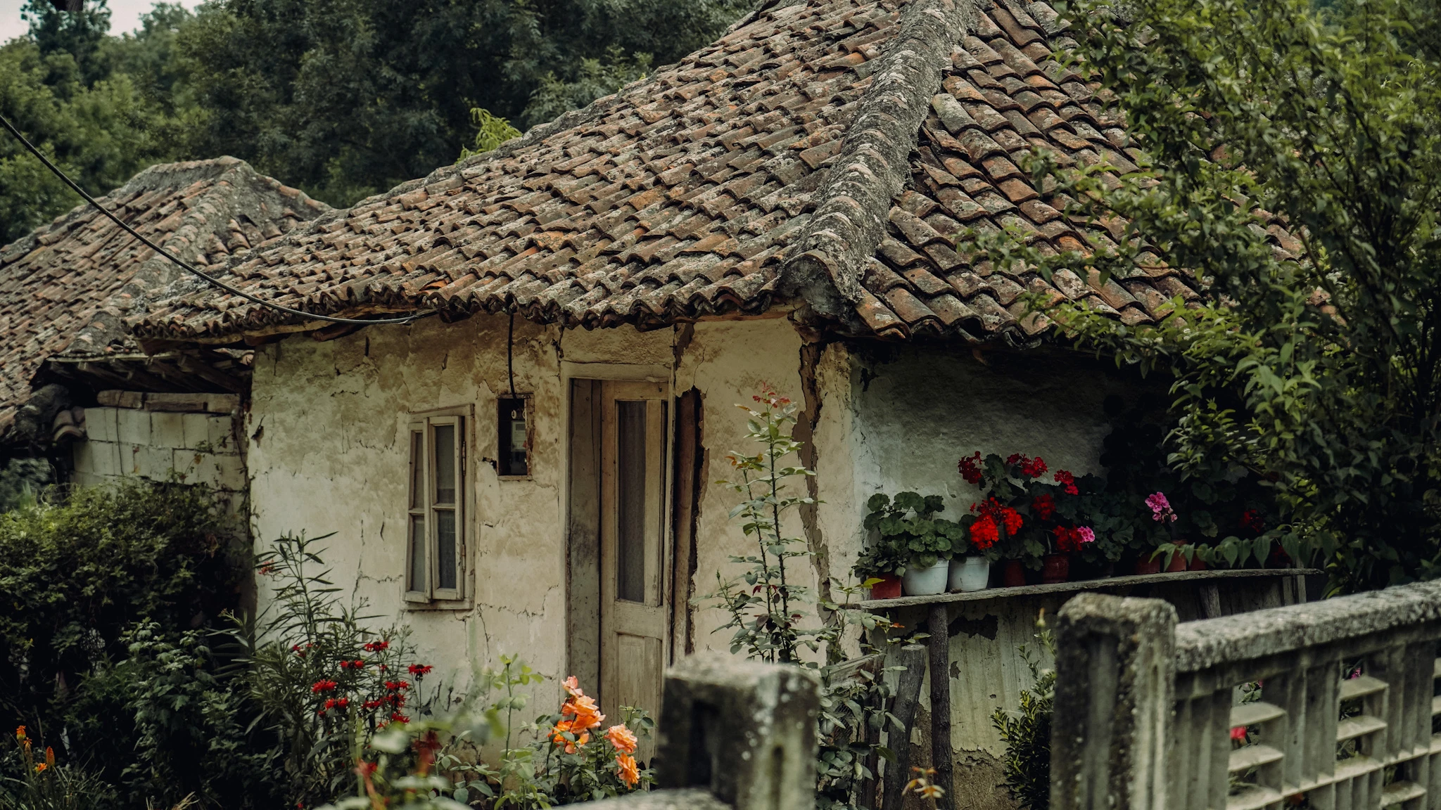 Remains of Peaceful Life old Serbian village house with a tiled roof by Lunar Lens Creative Agency