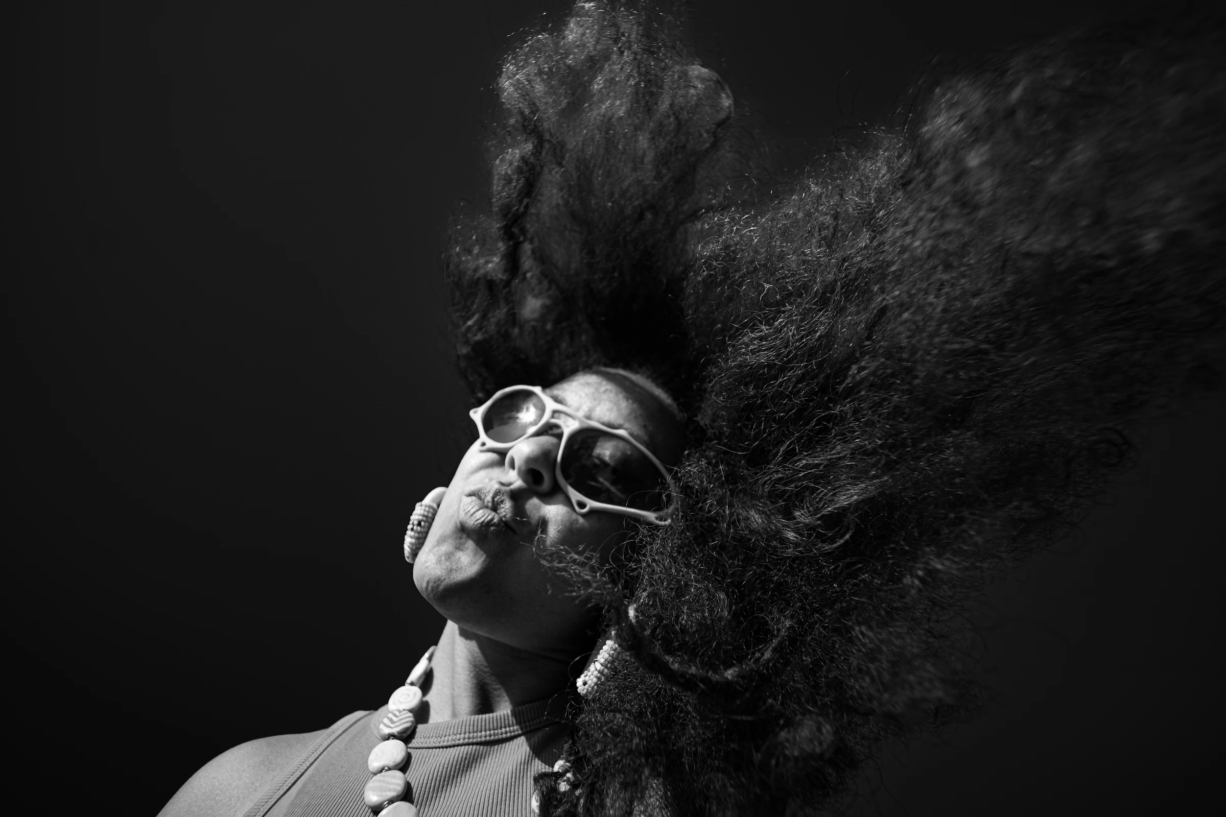 Black-and-white ITURA Studio sunglasses portrait with dramatic hair by Lunar Lens Creative Agency
