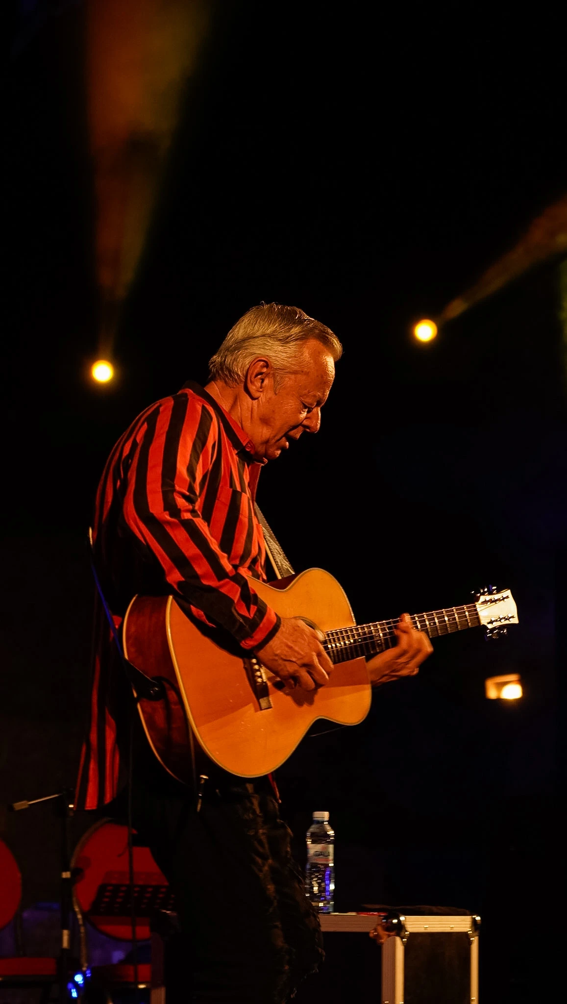 Guitar Art Festival guitarist playing under warm stage lights by Lunar Lens Creative Agency