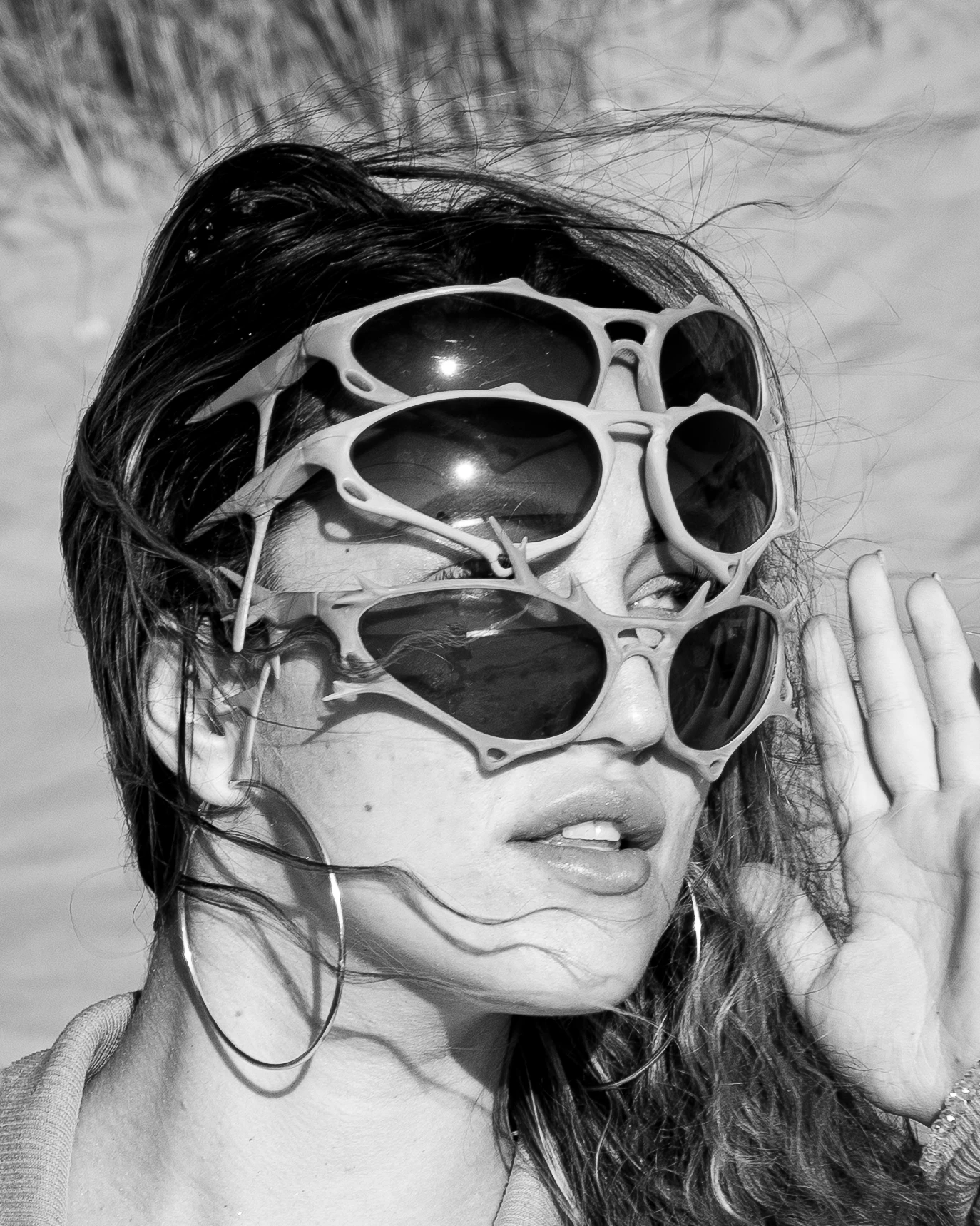 Black-and-white ITURA Studio close-up with stacked sculptural sunglasses by Lunar Lens Creative Agency